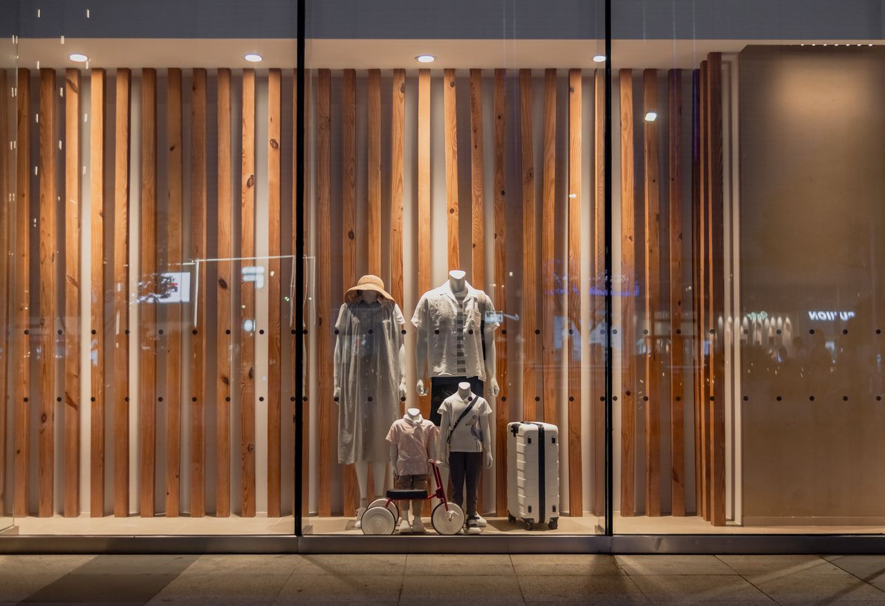 about-01 Elegant storefront display with mannequins in fashionable attire, seen in Wuhan, China.
