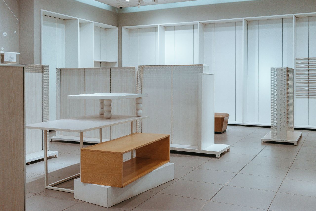 hero-img-02 Modern interior with minimalist white shelves and contemporary design elements.